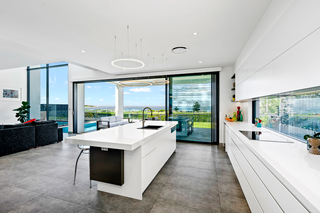 Greenhills spacious kitchen with big windows|Greenhills facade||GreenHills facade with pool|Greenhills living room with television|Gremmo Homes bathroom with bathtub|Greenhills livingroom