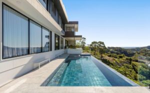 sandy beach custom homes|Monochrome modern living|Ocean view living|Modern cliffside residence|Sunken lounge area|Helical timber staircase|Terraced outdoor living|Luxury alfresco area|Infinity edge pool|JDG Constructions project|Modern architectural details|Light filled suite|Ocean view bedroom|Modern ensuite design|Sleek modern vanity|HIA award winner|Sandy Beach Custom Home|Ocean view living|Award winning architecture|Award winning Sandy Beach Custom Home